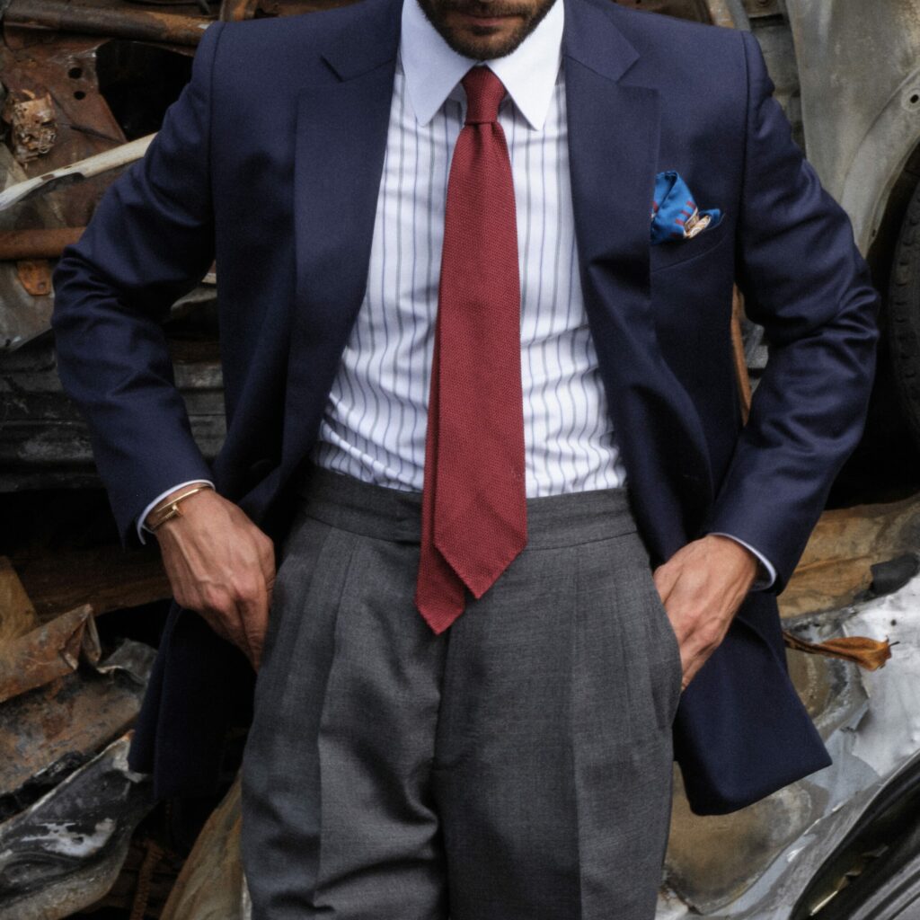 Navy blue suit, white-and-blue striped shirt, red tie, tailor-made by RIVES Paris.